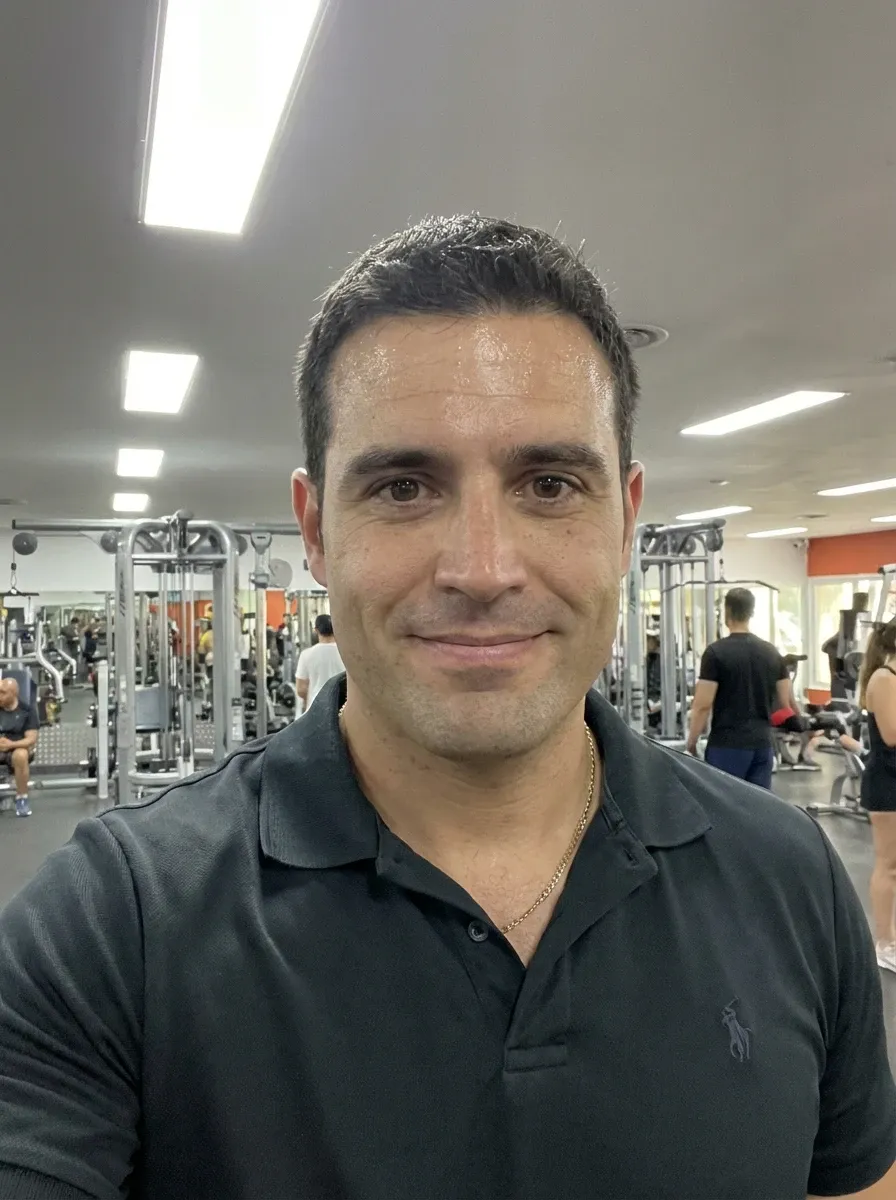 Original selfie input — man in a dark polo shirt indoors